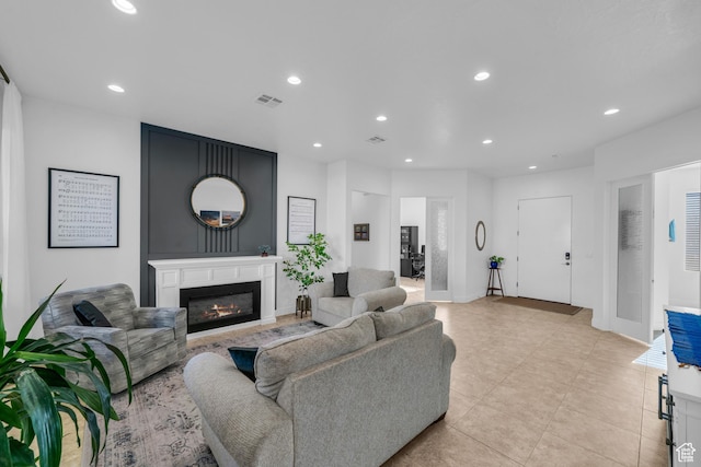 1226 W Province Way, St George, UT 84770 - living room featuring a glass covered fireplace, recessed lighting, light tile patterned flooring, and baseboards