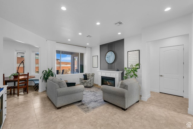 1226 W Province Way, St George, UT 84770 - living room featuring recessed lighting, a glass covered fireplace, and light tile patterned floors