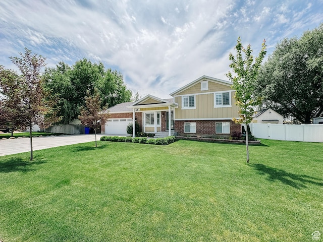 1557 N 2750 W, Plain City, UT 84404 - tri-level home featuring brick siding, driveway, and an attached garage