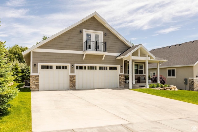 1232 Canyon Rd, Midway, UT 84049 - craftsman-style home with a balcony, stone siding, concrete driveway, and french doors