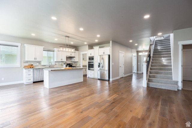 1232 Canyon Rd, Midway, UT 84049 - kitchen featuring stainless steel appliances, open floor plan, white cabinetry, recessed lighting, and a kitchen island