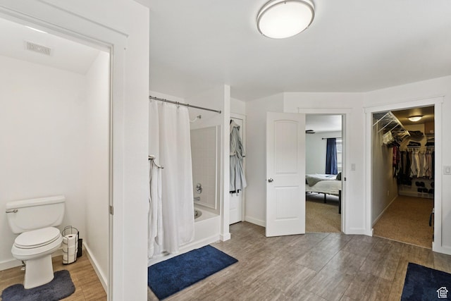 469 S Olive Way, Lehi, UT 84043 - bathroom with shower / tub combo with curtain, wood finished floors, toilet, a spacious closet, and baseboards