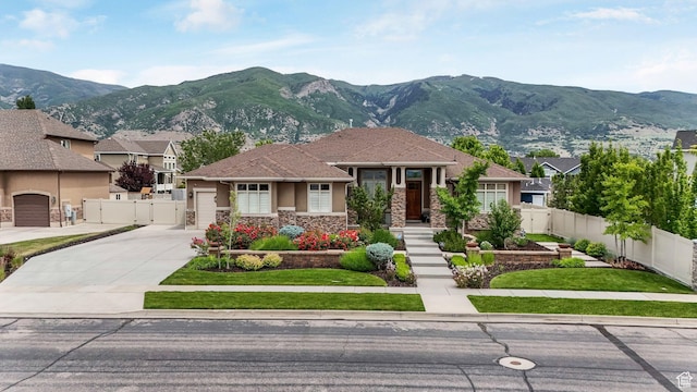 336 S 1400 W, Farmington, UT 84025 - prairie-style house featuring a gate, concrete driveway, a mountain view, and stone siding