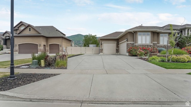 336 S 1400 W, Farmington, UT 84025 - view of property exterior with a garage, stone siding, stucco siding, a gate, and concrete driveway