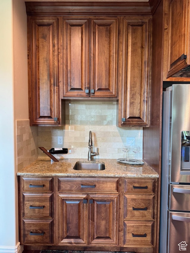 336 S 1400 W, Farmington, UT 84025 - kitchen featuring stainless steel fridge with ice dispenser, a sink, decorative backsplash, and light stone counters