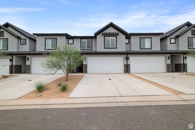 1334 S Bullfrog Ln, Washington, UT 84780 - view of property with stucco siding, a garage, stone siding, and driveway