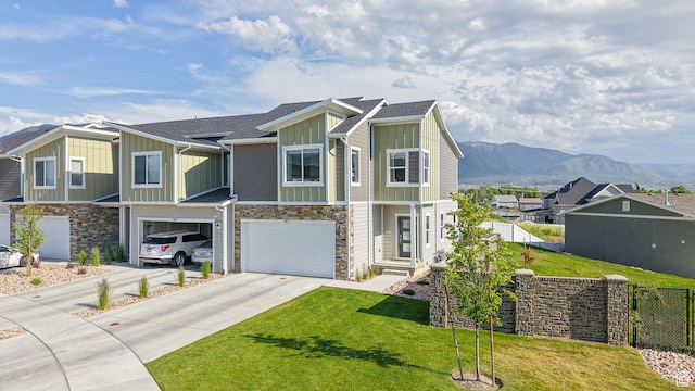 585 W 1420 S, Spanish Fork, UT 84660 - view of front facade with board and batten siding, driveway, an attached garage, and stone siding