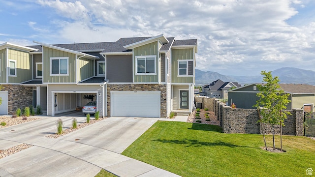 585 W 1420 S, Spanish Fork, UT 84660 - view of front of home with board and batten siding, driveway, stone siding, an attached garage, and a mountain view
