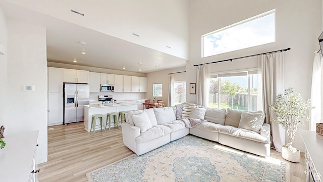 585 W 1420 S, Spanish Fork, UT 84660 - living room with light wood-type flooring, a high ceiling, and recessed lighting