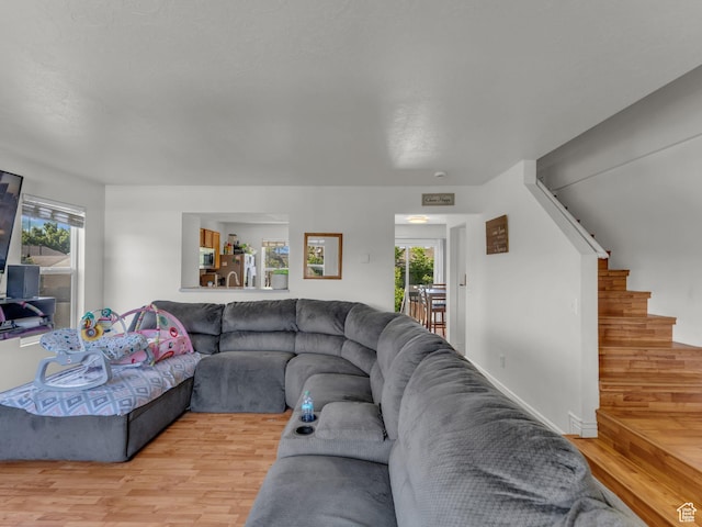 1177 W Dun Robin Ct, Salt Lake City, UT 84123 - living room featuring light wood-style floors, plenty of natural light, and stairs