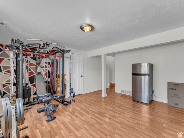 1177 W Dun Robin Ct, Salt Lake City, UT 84123 - exercise area featuring wood finished floors, a textured ceiling, and baseboards
