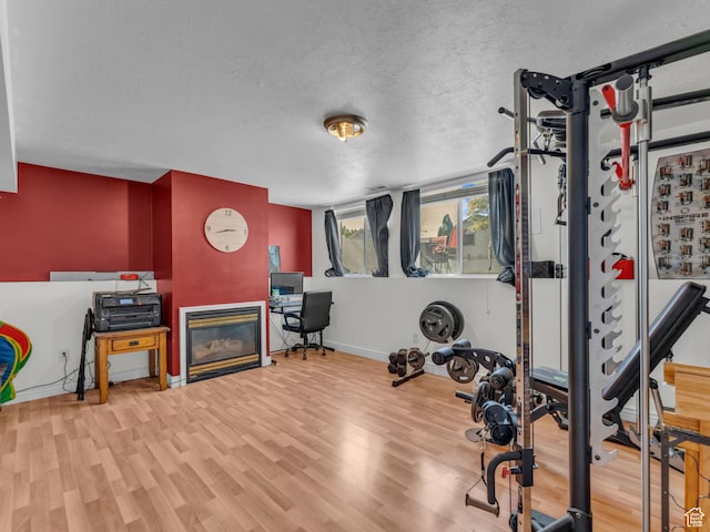1177 W Dun Robin Ct, Salt Lake City, UT 84123 - exercise area featuring wood finished floors, baseboards, and a glass covered fireplace