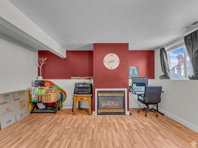 1177 W Dun Robin Ct, Salt Lake City, UT 84123 - office space featuring wood finished floors, a textured ceiling, a glass covered fireplace, and baseboards