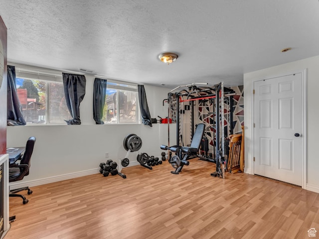 1177 W Dun Robin Ct, Salt Lake City, UT 84123 - workout area featuring wood finished floors, plenty of natural light, a textured ceiling, and baseboards