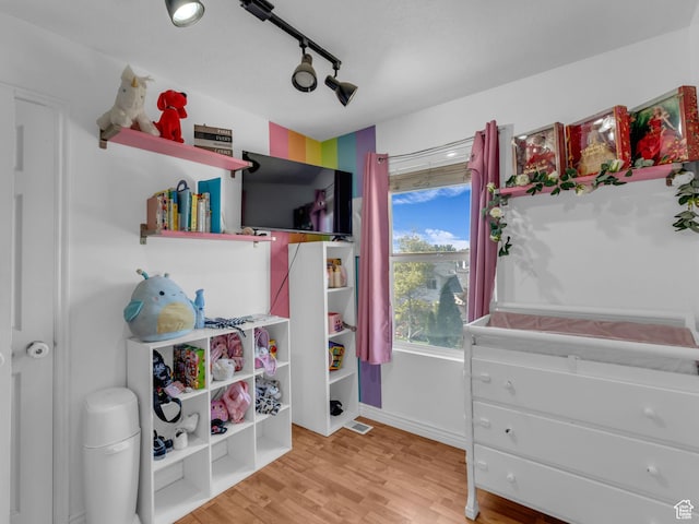 1177 W Dun Robin Ct, Salt Lake City, UT 84123 - bedroom with light wood finished floors, rail lighting, and baseboards