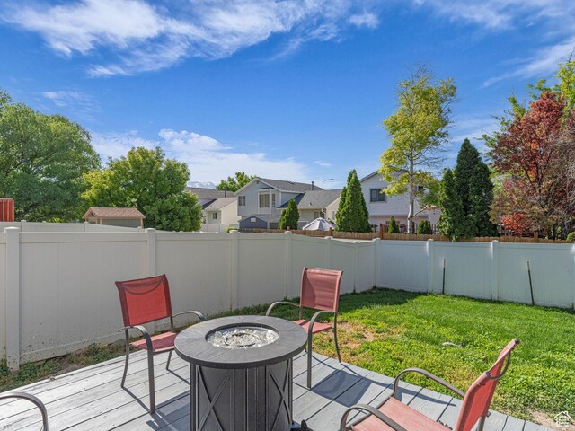 1177 W Dun Robin Ct, Salt Lake City, UT 84123 - wooden deck featuring an outdoor fire pit and a residential view