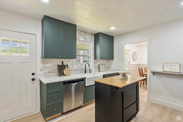 669 W 6th Ave, Midvale, UT 84047 - kitchen featuring dishwasher, a sink, green cabinets, light countertops, and light wood-style flooring