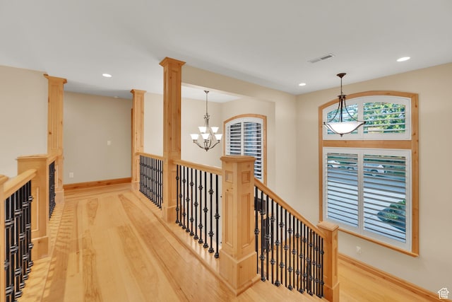 2345 E Lambourne Ave, Millcreek, UT 84109 - hall with wood finished floors, a chandelier, recessed lighting, baseboards, and ornate columns