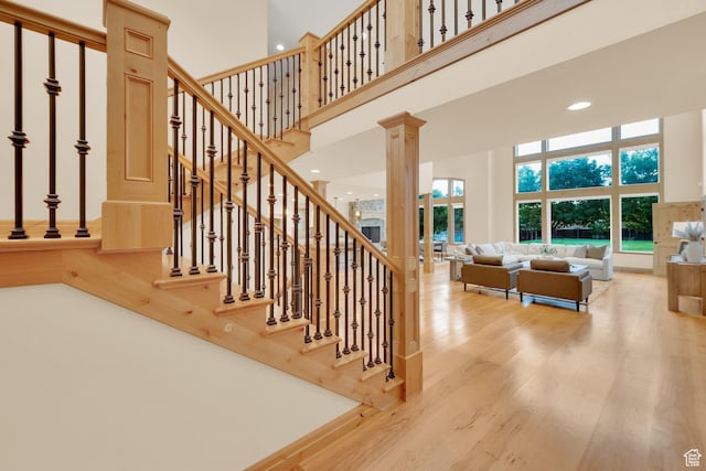 2345 E Lambourne Ave, Millcreek, UT 84109 - staircase with a towering ceiling, wood finished floors, recessed lighting, and decorative columns