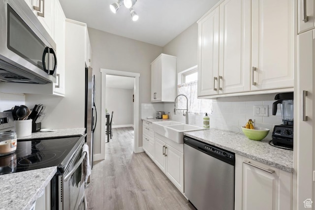 1532 S 200 E, Orem, UT 84058 - kitchen with stainless steel appliances, a sink, light wood-style flooring, and white cabinetry