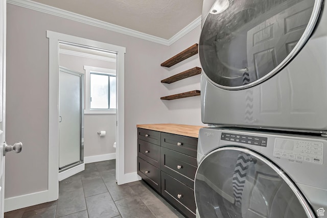 850 E 760 N, Lehi, UT 84043 - laundry room with stacked washer / drying machine, cabinet space, ornamental molding, baseboards, and tile patterned flooring