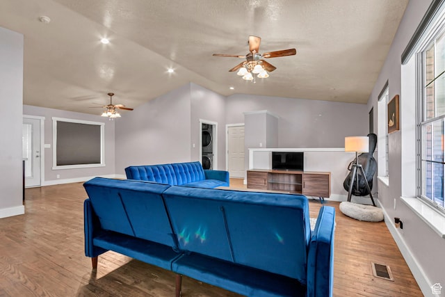 850 E 760 N, Lehi, UT 84043 - living area featuring stacked washer / drying machine, a ceiling fan, wood finished floors, baseboards, and a textured ceiling