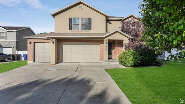 13764 S Rosie Ln, Herriman, UT 84096 - traditional home with a front lawn, an attached garage, concrete driveway, brick siding, and stucco siding