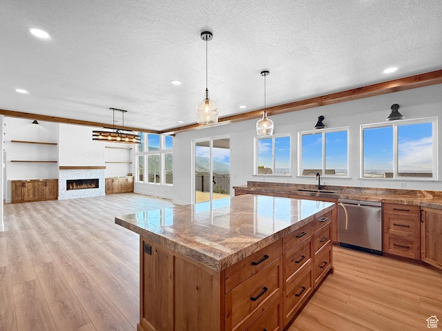 1141 E 4100 N, North Ogden, UT 84414 - kitchen featuring dishwasher, a textured ceiling, light wood-style flooring, a kitchen island, and a sink
