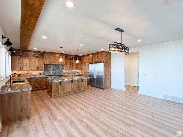 1141 E 4100 N, North Ogden, UT 84414 - kitchen with stainless steel built in refrigerator, brown cabinetry, a sink, recessed lighting, and a center island