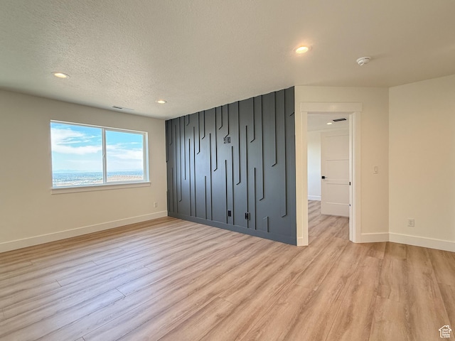 1141 E 4100 N, North Ogden, UT 84414 - unfurnished bedroom with light wood-style floors, baseboards, recessed lighting, and a textured ceiling