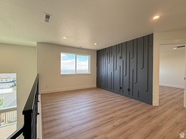 1141 E 4100 N, North Ogden, UT 84414 - unfurnished bedroom with light wood-style flooring, recessed lighting, baseboards, and a textured ceiling