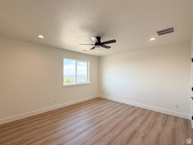1141 E 4100 N, North Ogden, UT 84414 - unfurnished room with light wood-type flooring, ceiling fan, baseboards, recessed lighting, and a textured ceiling
