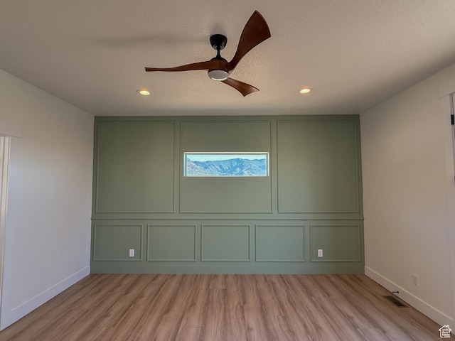 1141 E 4100 N, North Ogden, UT 84414 - empty room featuring a decorative wall, light wood-style floors, baseboards, a ceiling fan, and recessed lighting