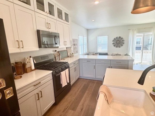 953 N 850 E Unit 229, Layton, UT 84041 - kitchen with stainless steel appliances, wood finished floors, healthy amount of natural light, light countertops, and recessed lighting