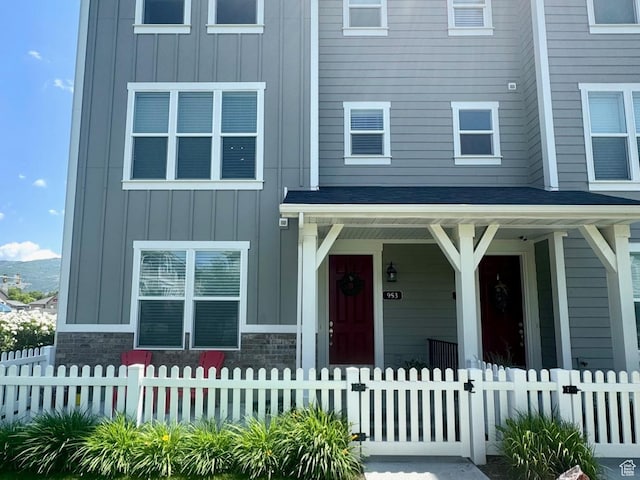953 N 850 E Unit 229, Layton, UT 84041 - multi unit property featuring board and batten siding, a porch, and a fenced front yard