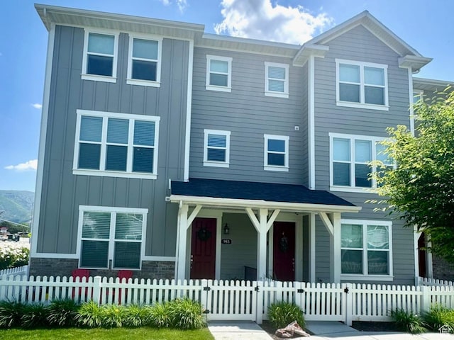 953 N 850 E Unit 229, Layton, UT 84041 - view of front of property featuring board and batten siding, a porch, and a fenced front yard