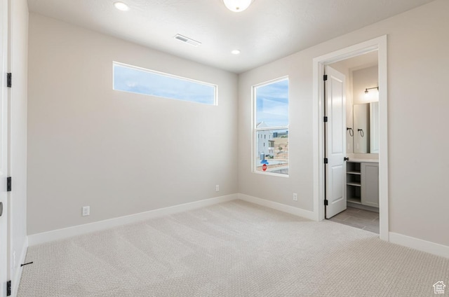 712 W Coastline Pl, St George, UT 84790 - unfurnished bedroom with light colored carpet, baseboards, recessed lighting, and connected bathroom