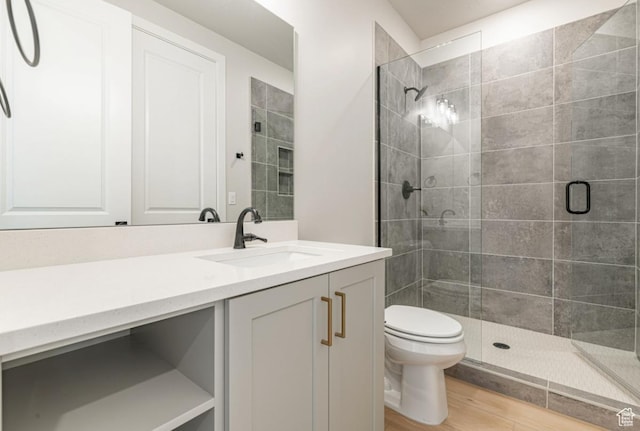 712 W Coastline Pl, St George, UT 84790 - bathroom with toilet, a stall shower, vanity, and wood finished floors