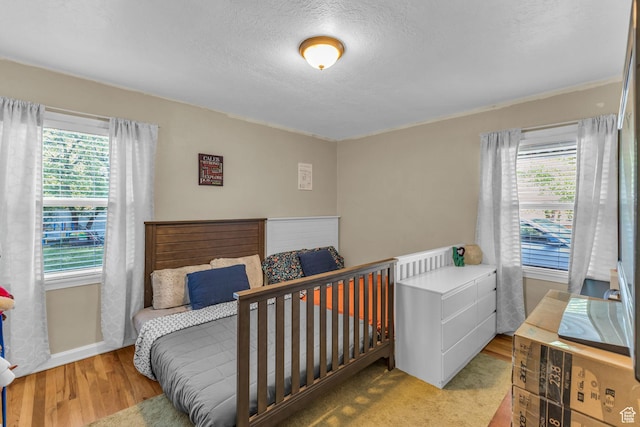 954 E 300 S, Provo, UT 84606 - bedroom with multiple windows, a textured ceiling, wood finished floors, and baseboards