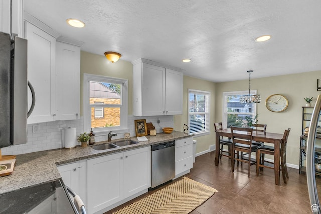 954 E 300 S, Provo, UT 84606 - kitchen featuring stainless steel dishwasher, a sink, electric range oven, tasteful backsplash, and white cabinetry