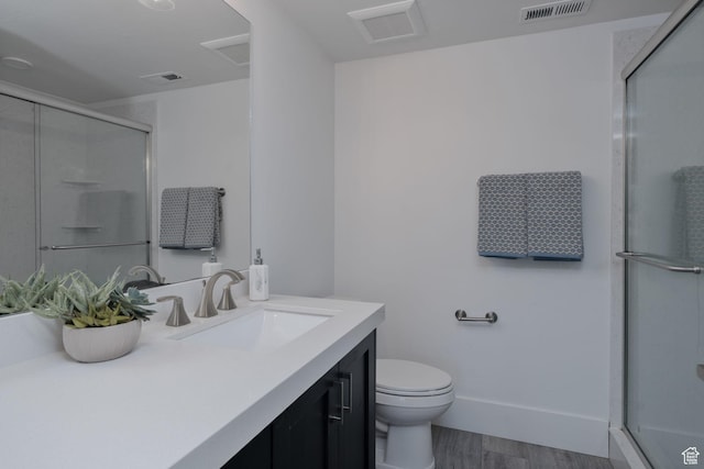 11103 N Shoreline Dr Unit # 3, Hideout, UT 84036 - bathroom featuring vanity, a shower with shower door, toilet, and wood finished floors