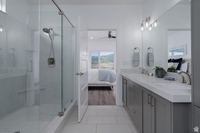 11103 N Shoreline Dr Unit # 3, Hideout, UT 84036 - ensuite bathroom with double vanity, a ceiling fan, a stall shower, and tile patterned floors