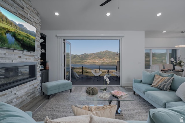 11103 N Shoreline Dr Unit # 3, Hideout, UT 84036 - living area with a mountain view, a ceiling fan, recessed lighting, wood finished floors, and a stone fireplace