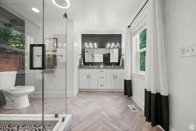 2524 E Redondo Ave, Salt Lake City, UT 84108 - full bath with baseboards, double vanity, a shower with door, and toilet
