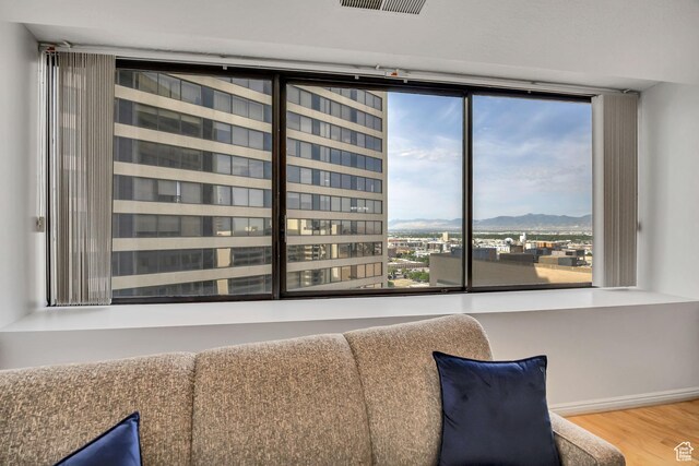 48 W 300 S Unit 1803N, Salt Lake City, UT 84101 - living area featuring wood finished floors, a mountain view, and baseboards