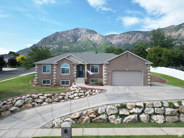 808 E 3400 N, North Ogden, UT 84414 - view of front of house with a garage, a mountain view, driveway, and brick siding
