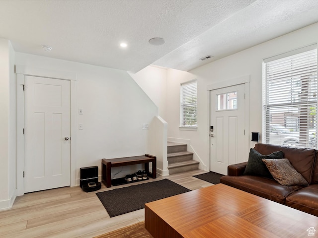 335 E Park Blvd S, Ogden, UT 84401 - living area featuring stairway, light wood-style floors, a textured ceiling, and baseboards