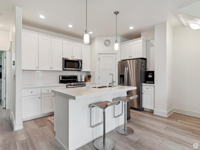 335 E Park Blvd S, Ogden, UT 84401 - kitchen featuring appliances with stainless steel finishes, a sink, light wood-style flooring, white cabinets, and light countertops