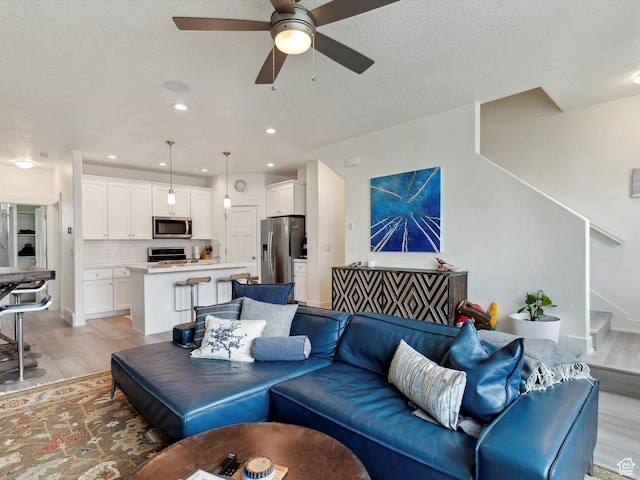 335 E Park Blvd S, Ogden, UT 84401 - living area with light wood-type flooring, ceiling fan, stairway, and recessed lighting