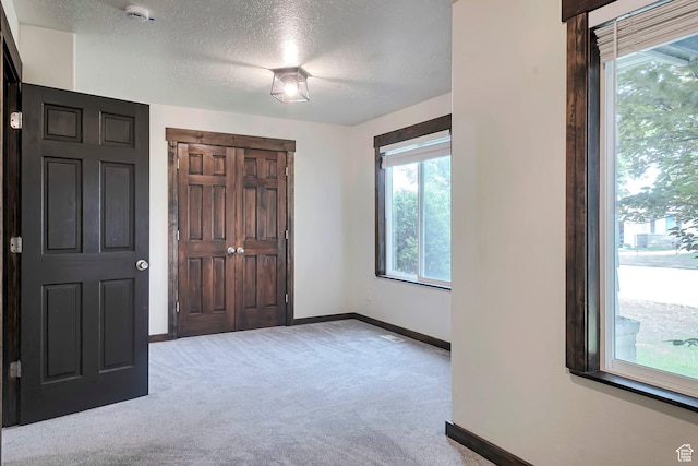 2101 W 325 S, Mapleton, UT 84664 - unfurnished bedroom with light carpet, a textured ceiling, multiple windows, and a closet